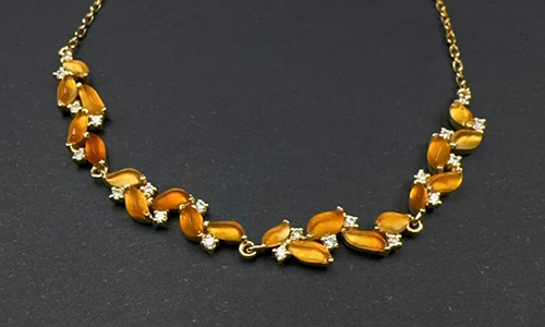 Vintage gold necklace with cat eye orange-yellow droplet stone and diamond accents